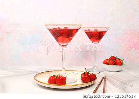 Festive alcoholic cocktail, red martini in glasses on a bright background with strawberries, summer bar concept, alcoholic drinks at a party, restaurant and cafe advertising, selective focus. 123514537
