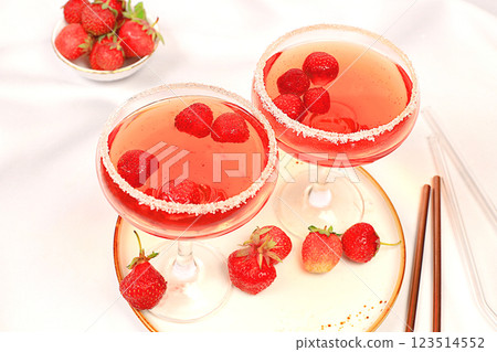Festive alcoholic cocktail, red martini in glasses on a bright background with strawberries, summer bar concept, alcoholic drinks at a party, restaurant and cafe advertising, selective focus. 123514552