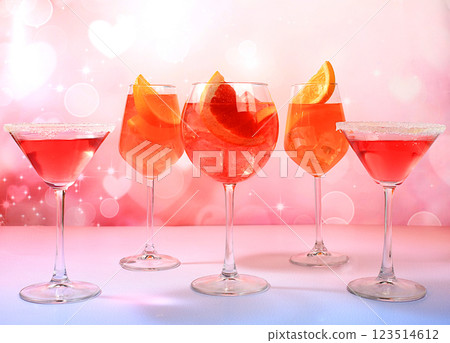 Festive alcoholic cocktail Aperol spritz and red martini in glasses on a bright background, bar concept and New Year's Eve, alcoholic drinks at a party, advertising for a restaurant, selective focus 123514612