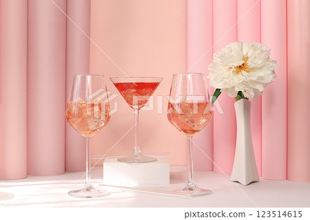 Modern summer still life with alcoholic cocktail Aperol spritz, champagne, pink martini and peony flowers on elegant modern background, minimal concept for bar and holiday party, cafe, advertising Modern summer still life with alcoholic cocktail Aperol spritz, champagne, pink martini and peony flowers on elegant modern background, minimal concept for bar and holiday party, cafe, advertising 123514615