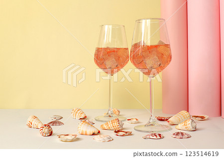 Modern summer still life with alcoholic cocktail Aperol spritz, champagne and seashells on elegant modern background, minimal concept for bar and holiday party, cafe, advertising banner, selective 123514619