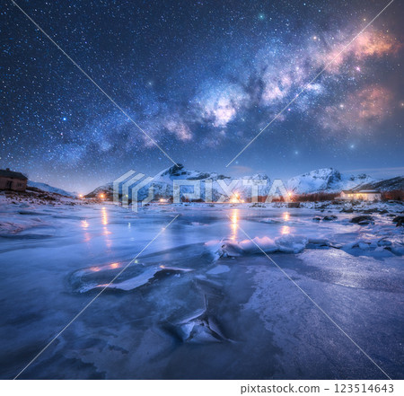 Milky Way arch, frozen sea and snowy mountains at starry night 123514643