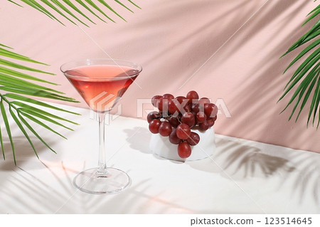 Modern still life with alcoholic margarita cocktail and grapes on pastel background with long hard shadows, minimal concept for bar, cafe, advertising banner, selective focus, space for text Modern still life with alcoholic margarita cocktail and grapes on pastel background with long hard shadows, minimal concept for bar, cafe, advertising banner, selective focus, space for text 123514645