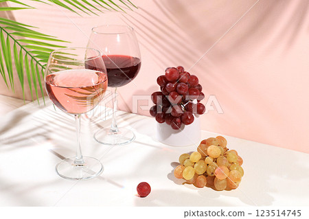Festive alcoholic cocktail, glasses of red and white wine on a background with shadows, bar concept, alcoholic drinks at a party, banner for advertising a restaurant or cafe, selective focus Festive alcoholic cocktail, glasses of red and white wine on a background with shadows, bar concept, alcoholic drinks at a party, banner for advertising a restaurant or cafe, selective focus 123514745