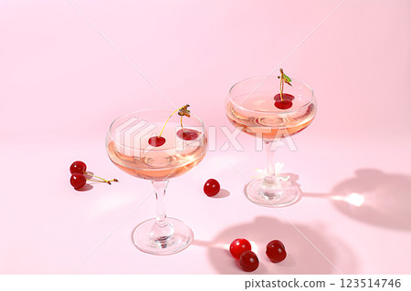 Modern still life with rose wine, alcoholic cocktail and cherry berries on elegant modern background, minimal concept for bar and holiday party, cafe, advertising banner, selective focus, space for 123514746