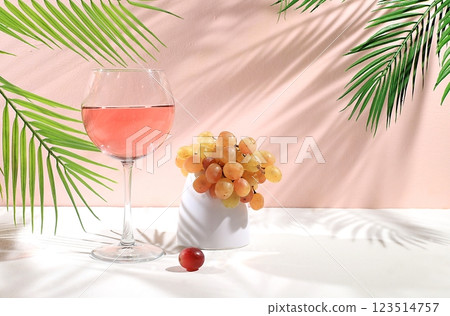 Modern still life with white wine, alcoholic cocktail and grapes on pastel background with long hard shadows, minimal concept for bar, cafe, advertising banner, selective focus, space for text Modern still life with white wine, alcoholic cocktail and grapes on pastel background with long hard shadows, minimal concept for bar, cafe, advertising banner, selective focus, space for text 123514757