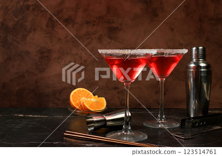 Festive alcoholic cocktail with red martini, lemonade, champagne in glasses on a dark background, bar concept, alcoholic drinks at a party, advertising for a restaurant, selective focus Festive alcoholic cocktail with red martini, lemonade, champagne in glasses on a dark background, bar concept, alcoholic drinks at a party, advertising for a restaurant, selective focus 123514761