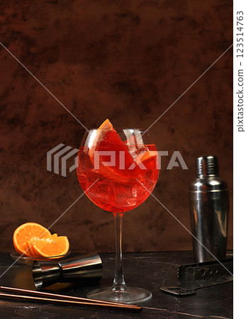 Festive alcoholic cocktail Aperol spritz in glasses on a dark background, concept for bar and New Year's Eve, alcoholic drinks at a party, advertising for a restaurant, selective focus 123514763