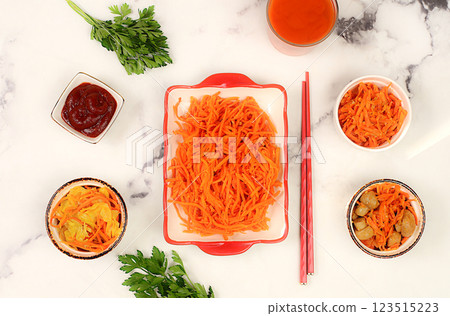 Korean kimchi side dish for barbecue dinner, carrot with sauce and hot pepper, a set of fermented foods good for gut health. Carrot, cabbage, garlic, parsley and juice on concrete background, healthy Korean kimchi side dish for barbecue dinner, carrot with sauce and hot pepper, a set of fermented foods good for gut health. Carrot, cabbage, garlic, parsley and juice on concrete background, healthy 123515223