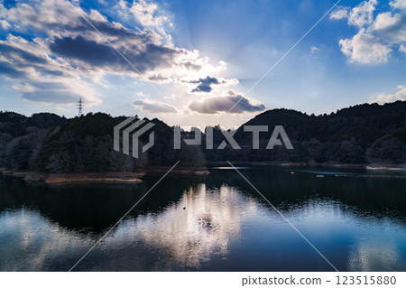 The temperature is rising and it's starting to feel like spring at Nara Nunome Dam. The beautiful lake surface reflects the blue sky. The temperature is rising and it's starting to feel like spring at Nara Nunome Dam. The beautiful lake surface reflects the blue sky. 123515880