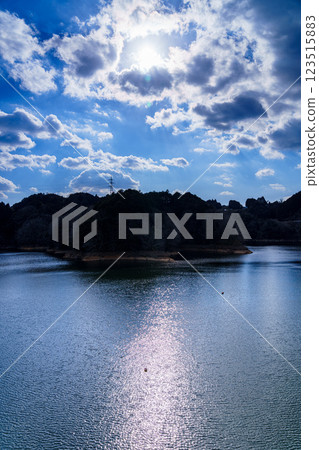 The temperature is rising and it's starting to feel like spring at Nara Nunome Dam. The beautiful lake surface reflects the blue sky. The temperature is rising and it's starting to feel like spring at Nara Nunome Dam. The beautiful lake surface reflects the blue sky. 123515883