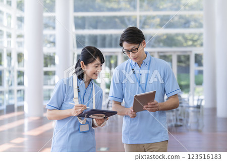 Facility staff holding a meeting while looking at a tablet 123516183