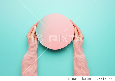 Hands with a pastel orb backdrop 123516472