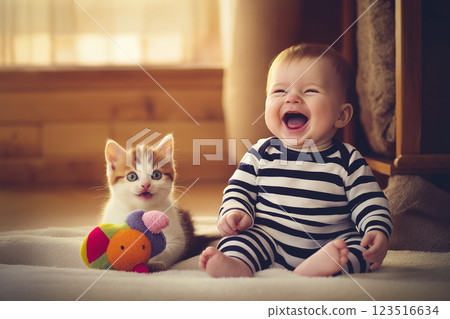 Kitten and baby laughter with striped toy creating a playful and cute happy scene Kitten and baby laughter with striped toy creating a playful and cute happy scene 123516634