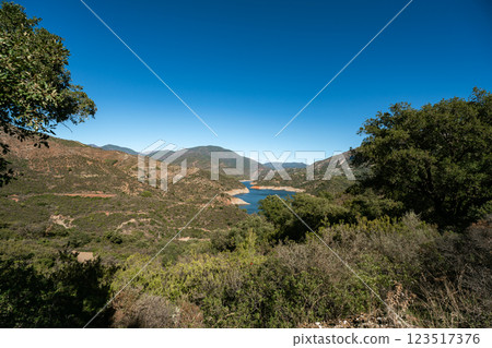 Expansive mountainous landscape with serene lake under clear blue sky, La Concepcion reservoir in 123517376
