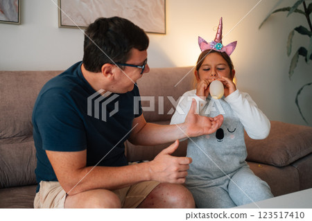 Caucasian father and young daughter enjoying playtime indoors at home 123517410