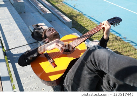 Young Musician Player Having Fun Making Chords With Classical Guitar 123517445