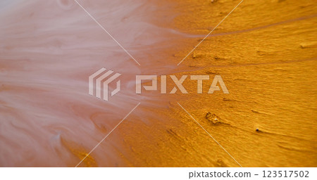 Glitter blob. Paint burst. Shiny golden precious sparkling liquid explosion spill particles. Art metal powder blotch abstract blur background. 123517502