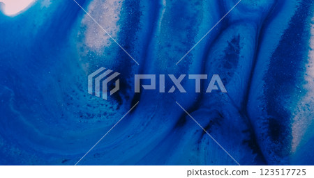 Shimmering dust. Sand paint. Blue acrylic mass sparkling flow smooth spread on wet frost surface. Shine powder gel spill abstract background. 123517725