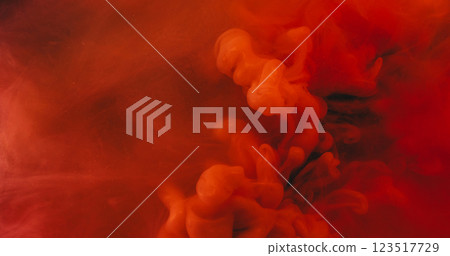 Bright fume. Dye spread. Watercolor blob drop ink mix spill in color water. Red orange art moisture texture blur abstract background. 123517729