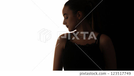 Beauty silhouette. Face contouring. Dark contrast outline of relaxed confident woman isolated on white copy space background. 123517749
