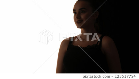 Beauty silhouette. Inspired face. Dark contrast outline of cheerful smiling woman isolated on white copy space background. Beauty silhouette. Inspired face. Dark contrast outline of cheerful smiling woman isolated on white copy space background. 123517754
