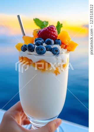 Tropical cocktail highlighted by coconut and kiwi on bright sandy beach. Tropical charm of cocktail radiates refreshing sweetness, bringing essence of coastal relaxation. 123518322