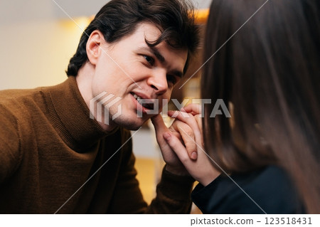 Intimate conversation between a young couple in a cozy cafe setting Intimate conversation between a young couple in a cozy cafe setting 123518431
