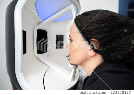Woman interacting with advanced facial recognition technology at a tech lab Woman interacting with advanced facial recognition technology at a tech lab 123518527