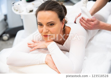 Woman receiving a relaxing massage therapy at a wellness center Woman receiving a relaxing massage therapy at a wellness center 123518528
