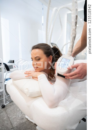 Woman enjoying a relaxing treatment at a wellness center in daytime Woman enjoying a relaxing treatment at a wellness center in daytime 123518542