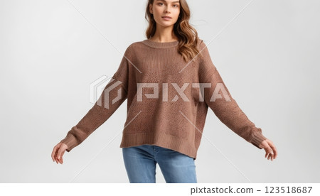 An oversized brown sweater with a relaxed design, perfect for cool weather layering. Ideal for fashion shoots and cozy lifestyle imagery. 123518687