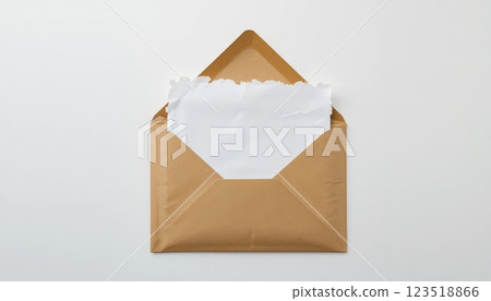 Open kraft envelope with a torn white note card. Suitable for stationery brands, greeting card designs, or correspondence concepts. 123518866