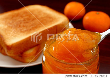 Mandarin jam scooped with a spoon Mandarin jam scooped with a spoon 123519081