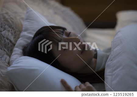 A young woman sleeping in bed A young woman sleeping in bed 123519265