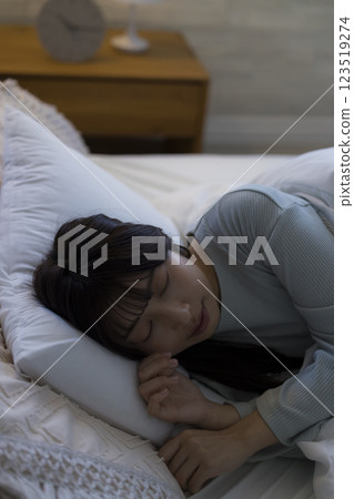 A young woman sleeping in bed 123519274