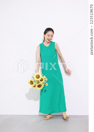 Smiling woman holding a bouquet of sunflowers Smiling woman holding a bouquet of sunflowers 123519670