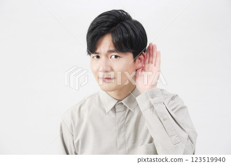 Man, listening with hand on ear, 20s, white background 123519940