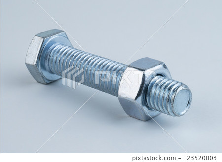 Close-up of a metal bolt with nuts on either side, showcasing threads and shine 123520003