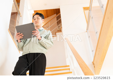 Construction worker inspecting the interior of a house 123520615