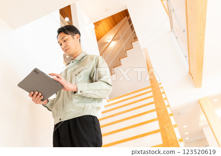 Construction worker inspecting the interior of a house Construction worker inspecting the interior of a house 123520619