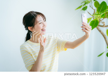 在房間裡操作智能手機的女人 123520947