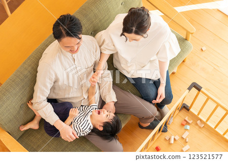 A young couple with a child playing in the living room A young couple with a child playing in the living room 123521577