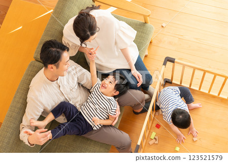 A young couple with a child playing in the living room 123521579