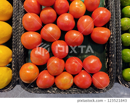 Fresh Red Tomatoes in Woven Baskets at a Market Display Fresh Red Tomatoes in Woven Baskets at a Market Display 123521843