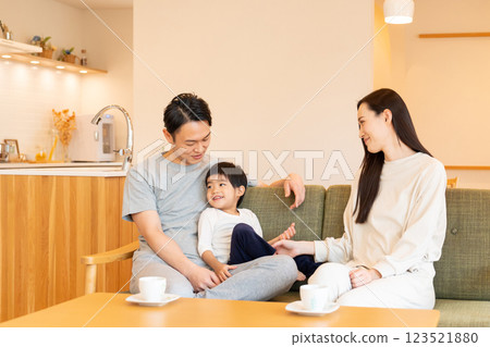 A young family relaxing in the living room A young family relaxing in the living room 123521880