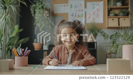 Happy Child Drawing at Desk in Cozy Indoor Environment 123522129