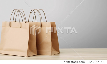 Brown Paper Bags on a Wooden Table Against a Light Background 123522146