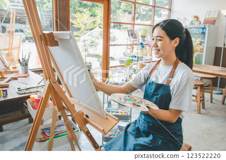 Art student drawing with watercolor painting on canvas doing some art projects on studio workshop Art student drawing with watercolor painting on canvas doing some art projects on studio workshop 123522220