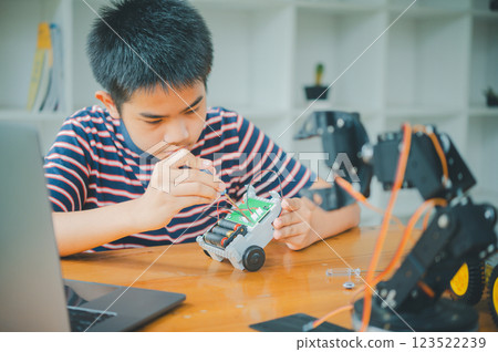 Asian boy learning and studying the work of technology robots.homeschool and science for tech project. playing childhood kids hobby leisure lifestyle people toys robotics technology. Asian boy learning and studying the work of technology robots.homeschool and science for tech project. playing childhood kids hobby leisure lifestyle people toys robotics technology. 123522239